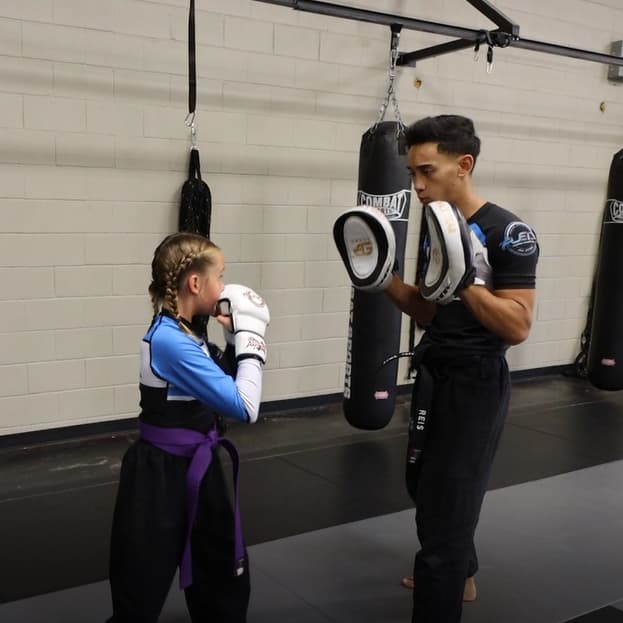 Older students training in a youth martial arts class